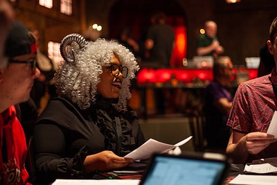 Inclusive groups give us a sense of belonging. Image of a black woman with white curly hair, horns, and glasses with a character sheet in front of her. 

"Women playing in D&D"
Image from Pouazity on Flikr.com